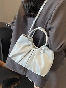Light blue ruched handbag in shiny oil wax leather with circular top handles and strap
