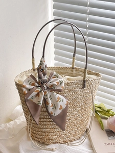 Handwoven straw bucket bag with floral ribbon bow and inner drawstring for summer beach