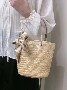 Handmade woven bucket bag with floral scarf detail for summer beach vacations and commuting