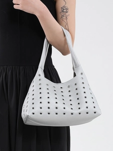 Silver studded handbag in textured lychee leather with industrial eyelet accents
