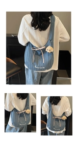 Detail showing blue denim tote with white stripes, pink bow, and puppy charm decoration