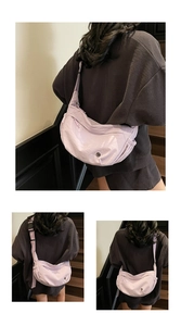 Detail view of lavender crescent crossbody bag showing textured fabric and adjustable strap