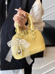 Litchi pattern yellow shell handbag with a pearl bow pendant and double zippers