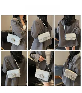 Detail shots of light blue patent leather shoulder bag with crystal square buckle