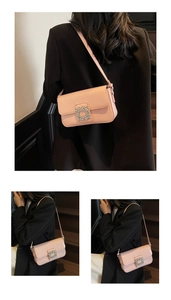 Close-up of pink patent leather shoulder bag featuring a sparkling crystal buckle detail