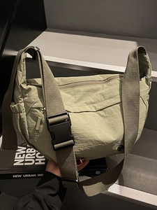 Minimalist olive green nylon crescent crossbody bag with adjustable wide strap for women