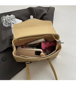 Internal view showing spacious storage for phone and wallet in beige leather bag