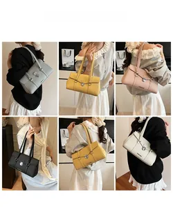 Model display of five colors of leather shoulder bags with elegant vertical straps and turn-lock