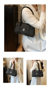 Close-up of black pebble leather handbag featuring silver twist lock and gold logo