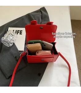 Interior view showing large capacity of red leather crossbody bag with cute ear detail