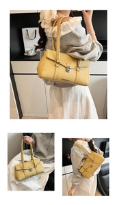 Detail of yellow lychee grain leather underarm bag with bright silver metal buckle