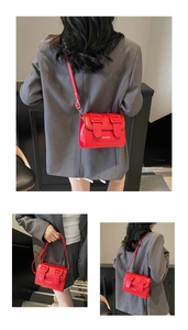 Three-way view of red crossbody square bag featuring sleek leather and dual buckles