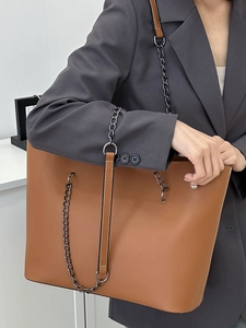 Minimalist large brown leather tote bag with chain strap and contrast stitching details