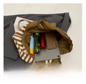 Detail view showing large internal capacity of the striped canvas tote bag for daily essentials