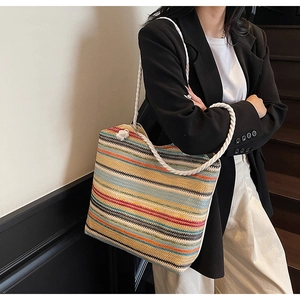 Close-up of woven tote bag with colorful stripes and durable thick cotton rope handles