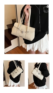 Detail view of cream white faux leather underarm bag with silver buckle and logo