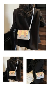 Close-up of tricolor crossbody satchel with adjustable strap on a minimalist staircase