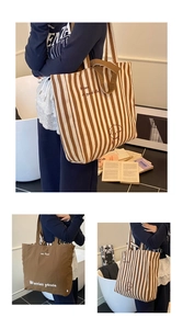 Detail showing dual-sided canvas tote bag with striped pattern and puppy cartoon print