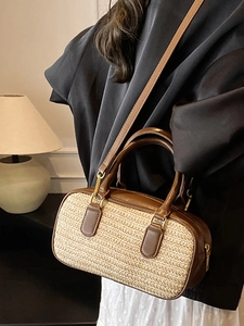 Fashionable straw woven crossbody bag with brown leather handles and gold clasp