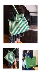 Detail of green striped canvas tote bag with cute dog embroidery and long shoulder straps