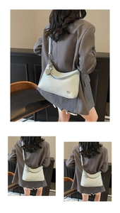 Detail of light blue lychee pattern leather bag with elegant pearl charm and silver hardware
