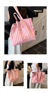 Detail showing pink striped canvas tote bag with dog print and Worries Pause slogan