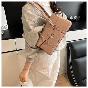 Pink lychee texture leather underarm bag featuring a silver twist lock closure