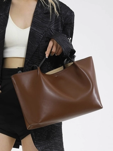Chic dark brown leather tote bag for women shown with a model for work and daily use