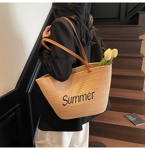 Detail of Summer embroidery on large straw tote bag with brown leather handles