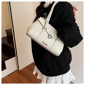 Close-up of beige textured leather underarm bag featuring a silver metal rotary lock and logo