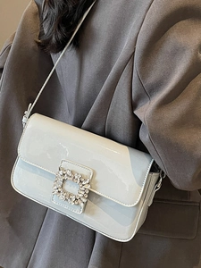 Elegant light blue patent leather shoulder bag featuring a sparkling crystal square buckle