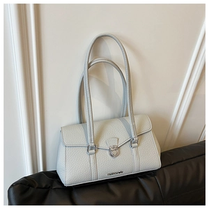 Detail of light blue pebble leather underarm bag with silver lock and metal logo