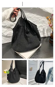 Detail of black woven tote bag featuring dense mesh texture and smooth leather-feel straps