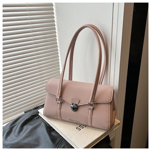Detail of the pink textured leather underarm bag with a silver twist lock and slim straps