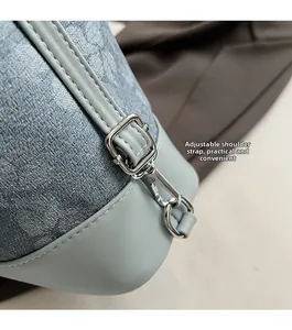 Close-up of adjustable strap with silver hardware and geometric jacquard fabric