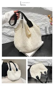 Detailed view of white crochet hobo bag with black leather handles and woven mesh texture