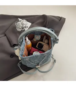 Spacious interior of blue denim floral bucket bag showing storage for phone and wallet