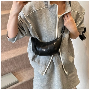 Detail of black croissant sling bag with CQIH '2DN lettering and knotted strap
