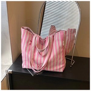 Detail of pink striped canvas tote bag with cute bear embroidery and wide handles