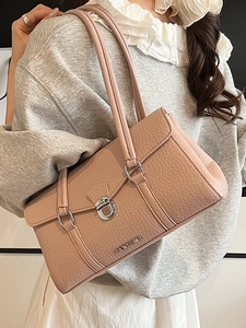Pinkish purple pebbled leather shoulder bag with silver twist lock and metal strap detail
