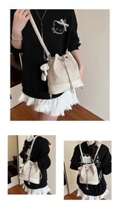 Close-up of cream jacquard bucket bag featuring pearl drawstring and cute plush bear charm