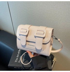 Detail of light beige Cambridge satchel bag with silver buckles and DAISHI&MAN branding
