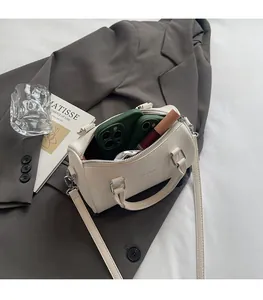 Detailed view of the off-white lychee leather Boston bag showing interior storage capacity