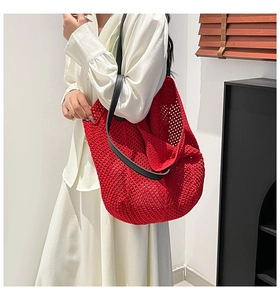 Detail of red crochet knit tote bag showing breathable hollow mesh and black leather strap