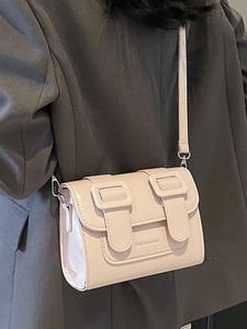 Chic pale pink structured satchel bag with buckle straps and silver hardware detailing