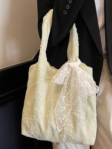 Pale yellow lace floral tote bag with white flower embroidery and large bow detail