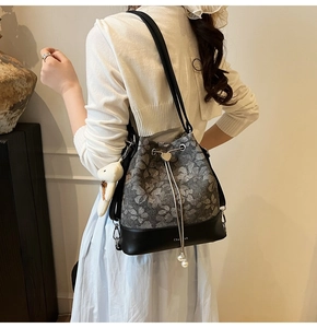 Close-up of floral bucket bag with drawstring closure and white pearl decoration