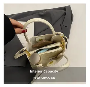 Internal capacity of white crocodile pattern bucket bag showing inner pouch and space
