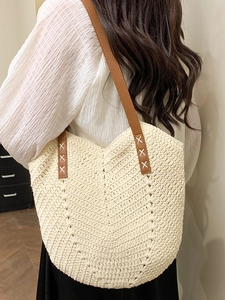 Schicke beige Strohtasche mit braunen Lederriemen und V-Webmuster für den Sommerurlaub