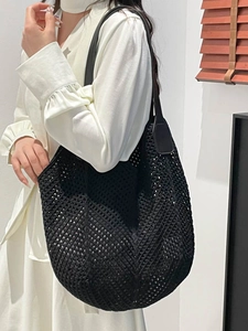 Minimalist black knit tote bag with mesh design and long shoulder strap for women